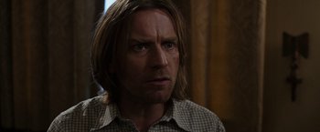 Movie still from “Miles Ahead” (2015), directed by Don Cheadle – A person with long hair; Close Up shot, Over the shoulder angle