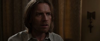 Movie still from “Miles Ahead” (2015), directed by Don Cheadle – A person with long brown hair; Close Up shot, Over the shoulder angle