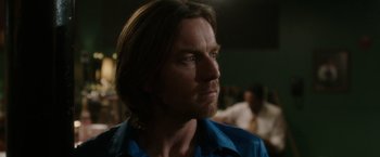 Movie still from “Miles Ahead” (2015), directed by Don Cheadle – A person wearing a blue shirt; Close Up shot, Over the shoulder angle