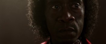 Movie still from “Miles Ahead” (2015), directed by Don Cheadle – A person's face with a dark background; Extreme Close Up shot, Low angle