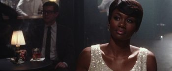 Movie still from “Miles Ahead” (2015), directed by Don Cheadle – A woman in a white dress and a man in a black suit; Close Up shot, Over the shoulder angle