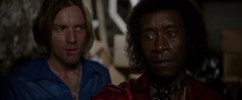 Movie still from “Miles Ahead” (2015), directed by Don Cheadle – Two people sitting next to each other in a room; Close Up shot, Over the shoulder angle