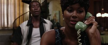 Movie still from “Miles Ahead” (2015), directed by Don Cheadle – A man and a woman sitting next to each other; Close Up shot, Over the shoulder angle