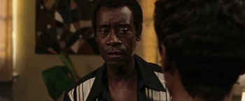 Movie still from “Miles Ahead” (2015), directed by Don Cheadle – A person looking at the camera; Close Up shot, Over the shoulder angle