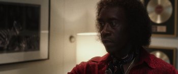 Movie still from “Miles Ahead” (2015), directed by Don Cheadle – A person wearing a red shirt; Close Up shot, Low angle