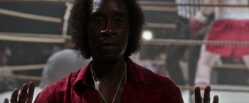 Movie still from “Miles Ahead” (2015), directed by Don Cheadle – A person wearing a red shirt; Close Up shot, Low angle
