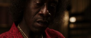Movie still from “Miles Ahead” (2015), directed by Don Cheadle – A person with a red shirt; Close Up shot, Low angle