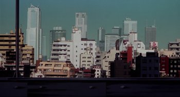 Movie still from “Millennium Actress” (2001), directed by Kô Matsuo – A view of a city skyline from a window; Extreme Wide shot, Low angle