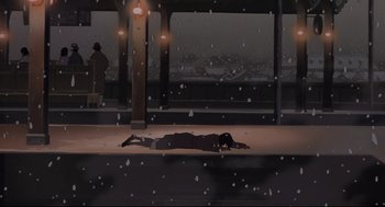 Movie still from “Millennium Actress” (2001), directed by Kô Matsuo – A person laying on the ground in the snow; Extreme Wide shot, High angle