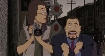 Movie still from “Millennium Actress” (2001), directed by Kô Matsuo – A cartoon of a man and a woman holding a camera; Close Up shot, High angle