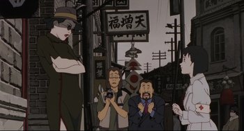 Movie still from “Millennium Actress” (2001), directed by Kô Matsuo – A group of people standing in front of a street sign; Medium shot, Over the shoulder angle