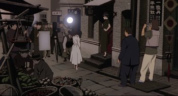 Movie still from “Millennium Actress” (2001), directed by Kô Matsuo – An illustration of a woman in a white dress and a man in a black suit; Wide shot, Over the shoulder angle