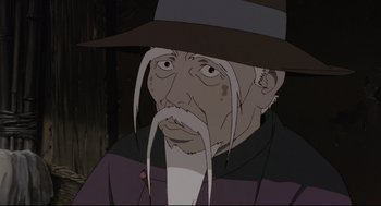 Movie still from “Millennium Actress” (2001), directed by Kô Matsuo – An old man with long white hair wearing a brown hat; Close Up shot, Low angle
