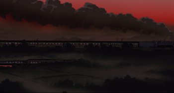 Movie still from “Millennium Actress” (2001), directed by Kô Matsuo – A train traveling on a train track in the middle of the night; Extreme Wide shot, Low angle