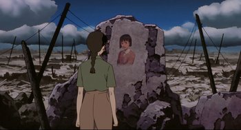 Movie still from “Millennium Actress” (2001), directed by Kô Matsuo – A woman standing in front of a stone with a picture of a girl; Medium shot, Over the shoulder angle