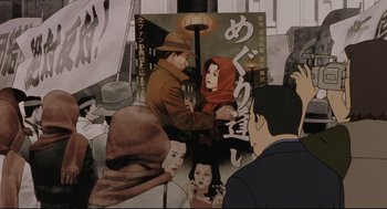 Movie still from “Millennium Actress” (2001), directed by Kô Matsuo – An illustration of a man and a woman in front of an advertisement; Medium shot, Over the shoulder angle