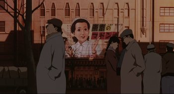 Movie still from “Millennium Actress” (2001), directed by Kô Matsuo – A group of people standing in front of an advertisement; Wide shot, Low angle