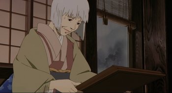 Movie still from “Millennium Actress” (2001), directed by Kô Matsuo – An animated person is holding a book in front of a window; Close Up shot, Low angle