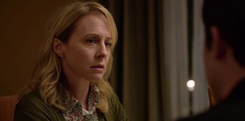 Movie still from “13 Reasons Why” (2017), created by Brian Yorkey – A person sitting in front of a curtain; Close Up shot, Over the shoulder angle