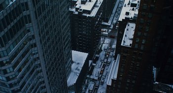 Movie still from “Mimic” (1997), directed by Guillermo del Toro – An aerial view of a city with a lot of snow on the ground; Extreme Wide shot, Overhead angle