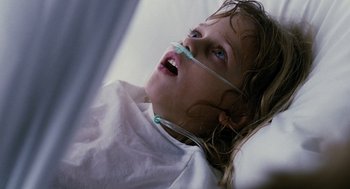 Movie still from “Mimic” (1997), directed by Guillermo del Toro – A little girl laying in a hospital bed with an oxygen mask on; Close Up shot, Low angle