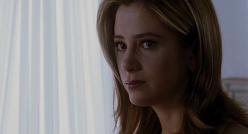 Movie still from “Mimic” (1997), directed by Guillermo del Toro – A woman's face in front of a window; Close Up shot, Over the shoulder angle