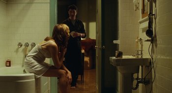 Movie still from “Mimic” (1997), directed by Guillermo del Toro – A man and a woman standing in front of a bathroom door; Medium shot, Over the shoulder angle