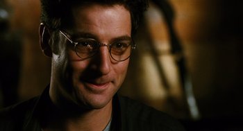 Movie still from “Mimic” (1997), directed by Guillermo del Toro – A person wearing glasses; Close Up shot, Over the shoulder angle