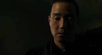 Movie still from “Mimic” (1997), directed by Guillermo del Toro – A person wearing a black shirt; Close Up shot, High angle