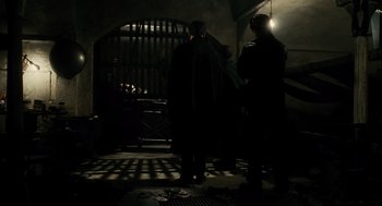 Movie still from “Mimic” (1997), directed by Guillermo del Toro – A group of people standing in a dark room; Wide shot, High angle