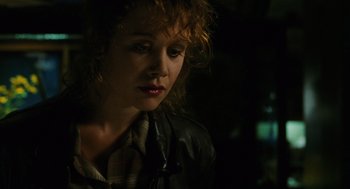 Movie still from “Mimic” (1997), directed by Guillermo del Toro – A person wearing a leather jacket; Close Up shot, High angle