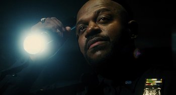 Movie still from “Mimic” (1997), directed by Guillermo del Toro – A person holding a flashlight; Close Up shot, Low angle