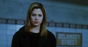 Movie still from “Mimic” (1997), directed by Guillermo del Toro – A woman in a black jacket is looking at the camera; Close Up shot, Low angle