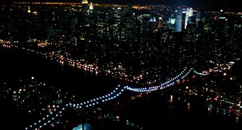 Movie still from “Mimic” (1997), directed by Guillermo del Toro – A view of a city at night from a helicopter; Extreme Wide shot, High angle
