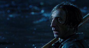 Movie still from “Mimic” (1997), directed by Guillermo del Toro – A person with a pipe in his mouth; Close Up shot, High angle