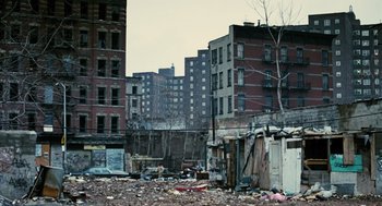 Movie still from “Mimic” (1997), directed by Guillermo del Toro – An urban area with a lot of trash and buildings; Extreme Wide shot, High angle