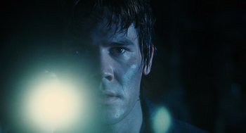 Movie still from “Mimic” (1997), directed by Guillermo del Toro – A person with a light in their face; Close Up shot, Low angle