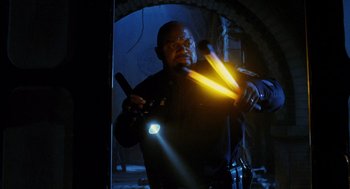 Movie still from “Mimic” (1997), directed by Guillermo del Toro – A man is holding a flashlight in a dark room; Medium shot, Low angle