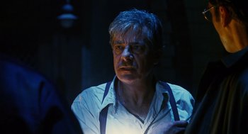 Movie still from “Mimic” (1997), directed by Guillermo del Toro – A man in a white shirt is looking at the camera; Close Up shot, Over the shoulder angle