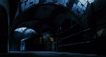 Movie still from “Mimic” (1997), directed by Guillermo del Toro – An empty train station at night with graffiti on the walls; Extreme Wide shot, Low angle