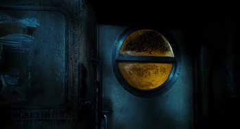 Movie still from “Mimic” (1997), directed by Guillermo del Toro – A round window in the wall of an old building; Close Up shot, Overhead angle