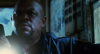 Movie still from “Mimic” (1997), directed by Guillermo del Toro – A person wearing glasses; Close Up shot, Low angle