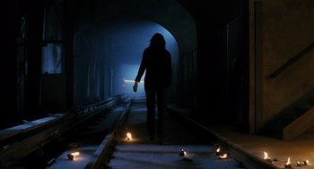Movie still from “Mimic” (1997), directed by Guillermo del Toro – A woman walking down a train track at night; Wide shot, Low angle