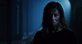 Movie still from “Mimic” (1997), directed by Guillermo del Toro – A person wearing a black shirt; Close Up shot, Low angle