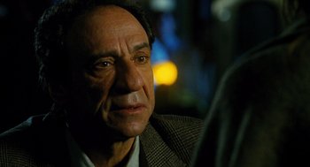 Movie still from “Mimic” (1997), directed by Guillermo del Toro – An older man is looking into the distance; Close Up shot, Over the shoulder angle