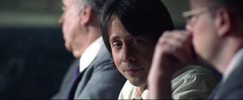 Movie still from “Miracle” (2004), directed by Gavin O'Connor – A man in a white shirt is looking at the camera; Close Up shot, Over the shoulder angle