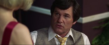 Movie still from “Miracle” (2004), directed by Gavin O'Connor – A person wearing a vest and a tie; Close Up shot, Over the shoulder angle