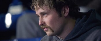 Movie still from “Miracle” (2004), directed by Gavin O'Connor – A person with a mustache; Close Up shot, Over the shoulder angle