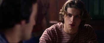 Movie still from “Miracle” (2004), directed by Gavin O'Connor – A man with long blonde hair sitting in front of a woman; Close Up shot, Over the shoulder angle