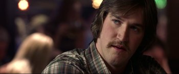 Movie still from “Miracle” (2004), directed by Gavin O'Connor – A person wearing a shirt with a mustache; Close Up shot, Over the shoulder angle